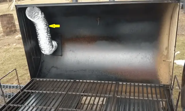A dryer vent inserted inside the cooking chamber photo.
