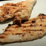 An Image of Grilled Chicken with Italian dressing.